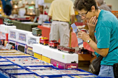 Helen Beatty looks at railroad cars for sale during the 47th Atlanta Model Train and Railroadiana Show and Sale at the North Atlanta Trade Center in Norcross on Saturday, August 9, 2014. 