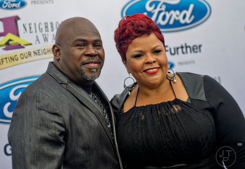 David Mann (left) and his wife Tamela pose for photos on the blue carpet before the 2014 Ford Neighborhood Awards at Philips Arena in Atlanta on Saturday, August 9, 2014. 