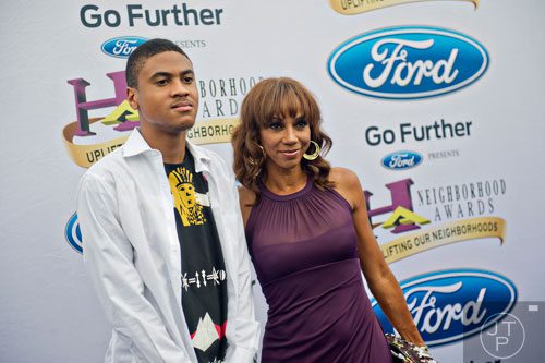 Holly Robinson Peete (right) and her son Rodney Jr. pose for photos on the blue carpet before the 2014 Ford Neighborhood Awards at Philips Arena in Atlanta on Saturday, August 9, 2014. 