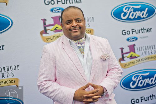 Roland Martin poses for photos on the blue carpet before the 2014 Ford Neighborhood Awards at Philips Arena in Atlanta on Saturday, August 9, 2014. 