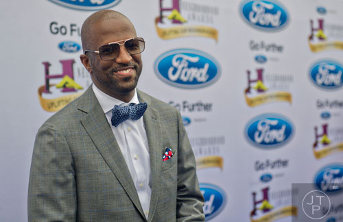 Rickey Smiley poses for photos on the blue carpet before the 2014 Ford Neighborhood Awards at Philips Arena in Atlanta on Saturday, August 9, 2014. 