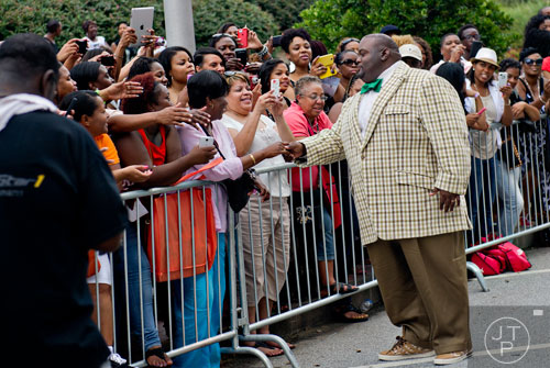 Comedian Lavell Crawford (right) greets fans before the 2014 Ford Neighborhood Awards at Philips Arena in Atlanta on Saturday, August 9, 2014. 