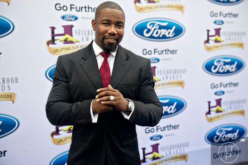 Michael Jai White poses for photos on the blue carpet before the 2014 Ford Neighborhood Awards at Philips Arena in Atlanta on Saturday, August 9, 2014. 