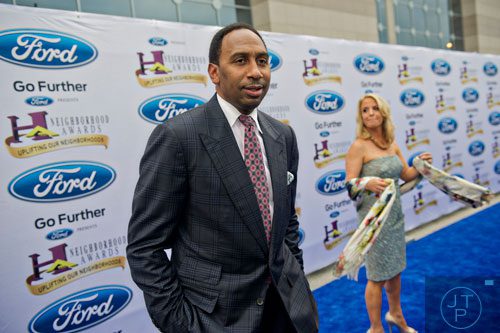 ESPN First Take commentator Stephen A. Smith poses for photos on the blue carpet before the 2014 Ford Neighborhood Awards at Philips Arena in Atlanta on Saturday, August 9, 2014. 