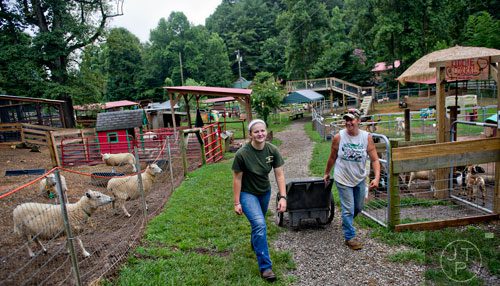 Kate Herndon (left) and Tina McGarry make their final rounds at the North Georgia Zoo and Petting Farm in Cleveland before the facility opens on Sunday, August 10, 2014.  