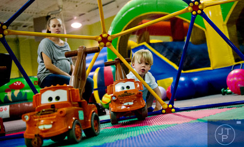 Weller Cox (right) plays with trucks as his mother Martha watches at HippoHopp in Atlanta on Thursday, August 14, 2014.   