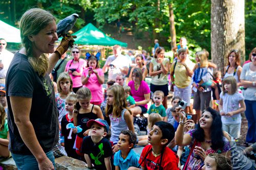 Stacy Truitt shows off a Mississippi kite, a bird of prey, during the Butterfly Festival at the Dunwoody Nature Center on Saturday, August 16, 2014. 