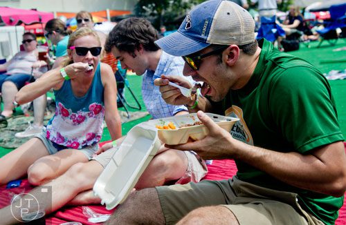  Jason Blessing (right) and Patrick and Kim Ketchersid eat barbeque as they wait for the music to start during the Decatur BBQ, Blues & Bluegrass Festival at Harmony Park in Decatur on Saturday, August 16, 2014. 