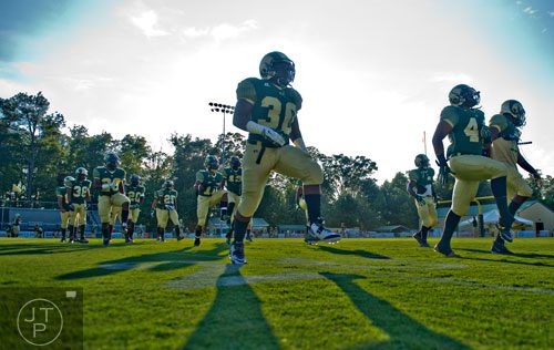 Grayson's Justin Lester (center) warms up with teammates before their game against Gainesville on Friday, August 29, 2014.  