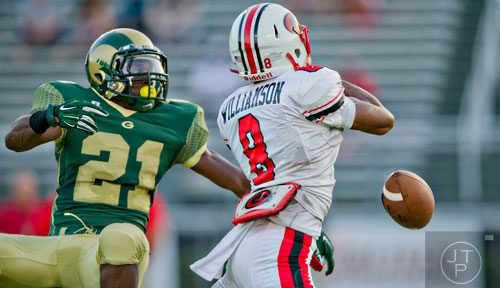 Grayson's Adesola Abisoye (21) breaks up a pass intended for Gainesville's Chris Williamson (8) on Friday, August 29, 2014.