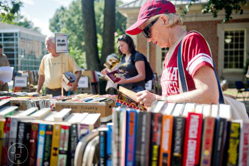 Jann Knowles looks at one of thousands of books for sale during the AJC Decatur Book Festival on Saturday, August 30, 2014. 