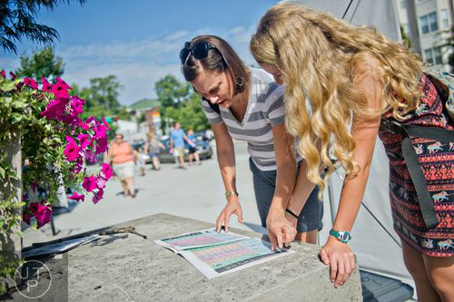 Catherine Brehm (left) and her daughter Margaret look at a schedule as they plan their next stop during the AJC Decatur Book Festival on Saturday, August 30, 2014. 