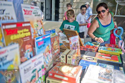 Rebekah Hart (right) and her son Jack look at books on Egyptology at one of the booths during the AJC Decatur Book Festival on Saturday, August 30, 2014. 