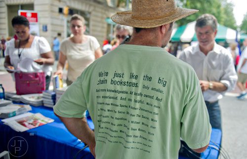 Frank Reiss (center) helps customers at the Atlanta Journal-Constitution booth during the AJC Decatur Book Festival on Saturday, August 30, 2014. 