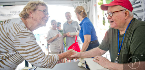Cheryl Peavyhouse (left) shakes hands with author Pat Conroy as he signs books during the AJC Decatur Book Festival on Saturday, August 30, 2014. 