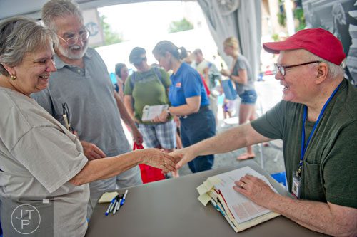Linda Adams (left) and her husband Richard shake hands with author Pat Conroy as he signs books during the AJC Decatur Book Festival on Saturday, August 30, 2014.