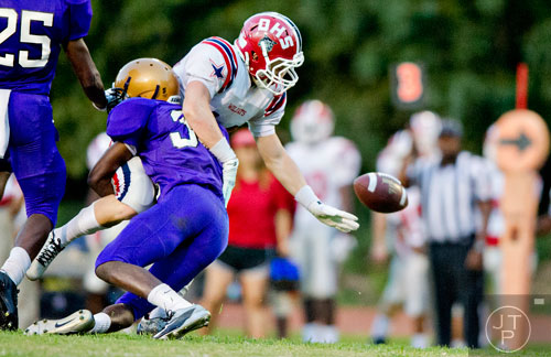 Lakeside-Dekalb's Semaj Williams (35) tackles Dunwoody's Chase Hawkins causing him to miss the ball on Friday, September 19, 2014. 