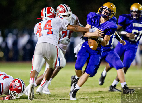 Dunwoody's Kirven Davis (44) tries to strip the ball out of the hands of Lakeside-Dekalb's Will Jernigan (right) on Friday, September 19, 2014.
