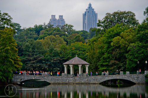 Participants in Wanderlust 108 cross the bridge over the lake at Piedmont Park in Atlanta on Sunday, September 28, 2014. 