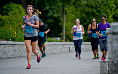 Hayley Thacher (left) runs towards the finish line during the 5k portion of Wanderlust 108 at Piedmont Park in Atlanta on Sunday, September 28, 2014. 