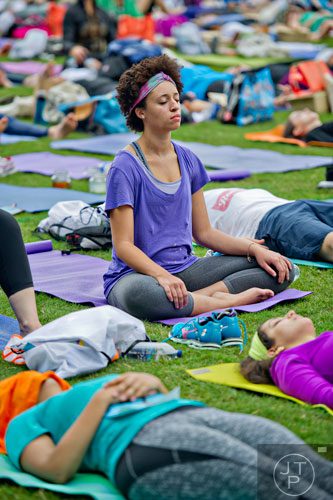 Macy Lister practices meditation during Wanderlust 108 at Piedmont Park in Atlanta on Sunday, September 28, 2014. 