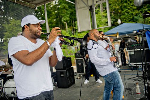 Melvin Jones (left) plays the trumpet as he and the rest of the Good Times Brass Band performs on stage during Wanderlust 108 at Piedmont Park in Atlanta on Sunday, September 28, 2014. 