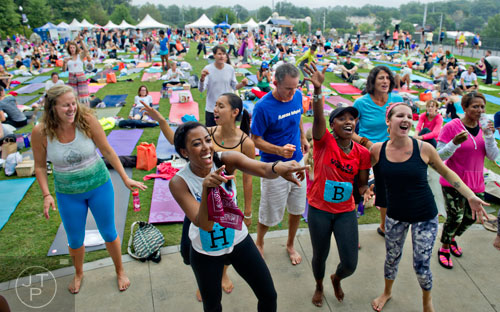 Bethany Richards (left), Gisselle Suarez, Sandy Chiu, Harry Averell, Koko Bergers, Lizzie Baxter, Dominique Angelecca and Monica Callender dance as the Good Times Brass Band performs on stage during Wanderlust 108 at Piedmont Park in Atlanta on Sunday, September 28, 2014. 