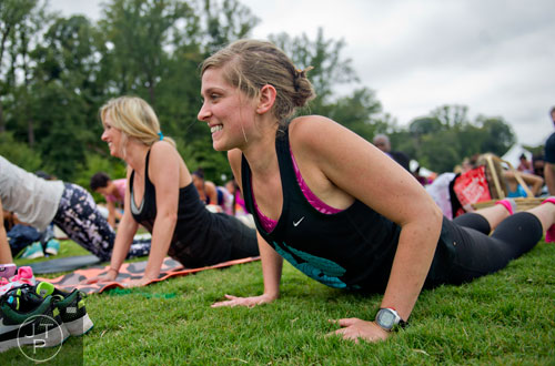 Amanda Kiza (right) stretches into a yoga pose during Wanderlust 108 at Piedmont Park in Atlanta on Sunday, September 28, 2014. 