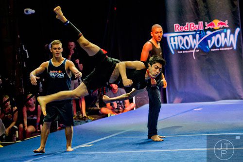 Jacob Pinto (center) flies through the air while teammates Bailey Payne (left) and Donovan Sheehan (right) watch during the Red Bull Throwdown Atlanta at the Tabernacle in Atlanta on Sunday, September 28, 2014. 