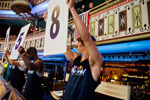 Nick Vail (right), one of five judges, holds up a score during the Red Bull Throwdown Atlanta at the Tabernacle in Atlanta on Sunday, September 28, 2014.