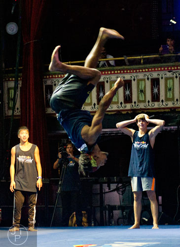 Jordan Okubo (left) and Kenneth Carr react as their teammate Will Coneys (center) flips through the air during the Red Bull Throwdown Atlanta at the Tabernacle in Atlanta on Sunday, September 28, 2014. 
