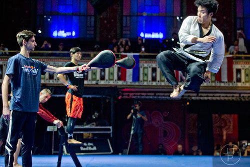 Mincheol Shin (right) kicks a target held by Noah Garret as he competes in the Red Bull Throwdown Atlanta at the Tabernacle in Atlanta on Sunday, September 28, 2014. 