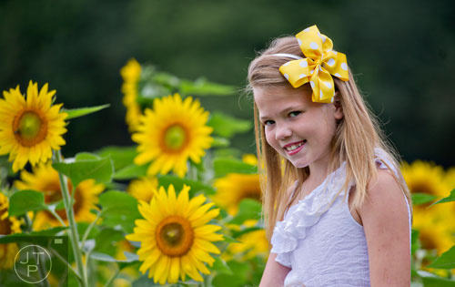 Tara Parks poses for photos by a field of sunflowers outside of Dawsonville on Sunday, September 14, 2014.
