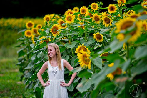 Alysyn Long poses for photos by a field of sunflowers outside of Dawsonville on Sunday, September 14, 2014.