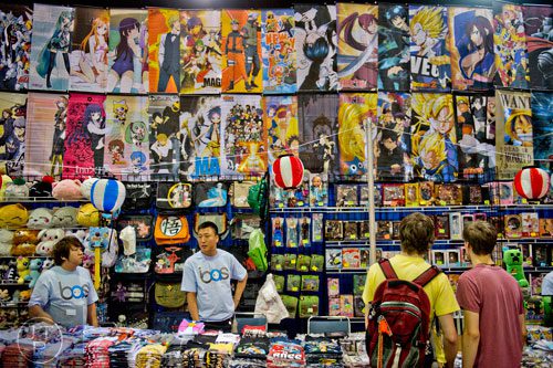 Colin Kiester (right) and his brother Fox look at different animation series themed tiles and shirts during the 2014 JapanFest at the Gwinnett Center in Duluth on Saturday, September 20, 2014. 