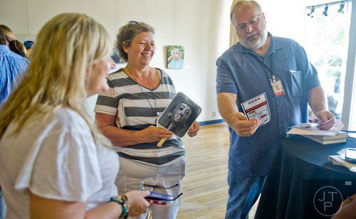Raymond Atkins (right), his wife Marsha and Cat Blanco talk inside the hospitality suite during the AJC Decatur Book Festival on Saturday, August 30, 2014. 