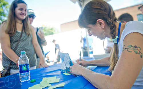 Lauren Myracle (right) signs a copy of her book for Hannah Mains during the AJC Decatur Book Festival on Saturday, August 30, 2014. 
