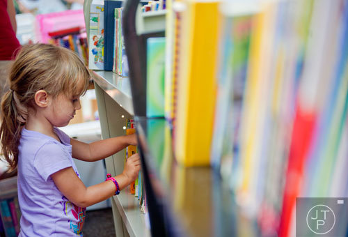 Sadie Walker thumbs through a section of children's books during the AJC Decatur Book Festival on Saturday, August 30, 2014. 
