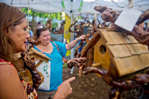 Debbie Moeller (left) and Tammy Bridges look at birdhouses during the 46th annual Yellow Daisy Festival at Stone Mountain Park on Saturday, September 6, 2014. 