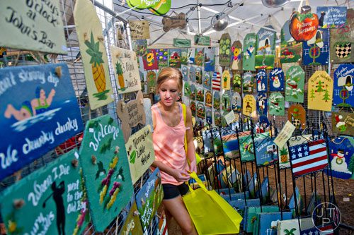 Melissa Bryan looks at pieces of artwork made from the slate roof of a church during the 46th annual Yellow Daisy Festival at Stone Mountain Park on Saturday, September 6, 2014. 