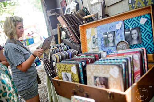 Jessica Ives (left) checks out handmade picture frames during the 46th annual Yellow Daisy Festival at Stone Mountain Park on Saturday, September 6, 2014. 