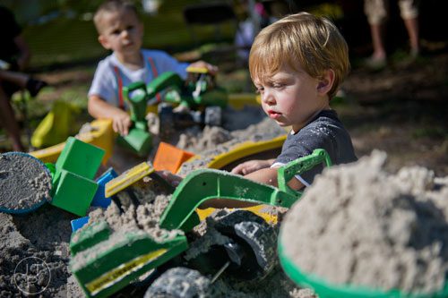 Kasen Sweet (right) and Nicholas Hoeh play in the sandbox inside the children's area during the 46th annual Yellow Daisy Festival at Stone Mountain Park on Saturday, September 6, 2014. 