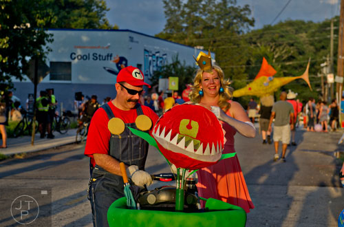 Dressed as Mario and Princess Peach, Bill Burnard (left) and Kate Gunderson wait for the start of the Atlanta Beltline Lantern Parade on Saturday, September 6, 2014. 
