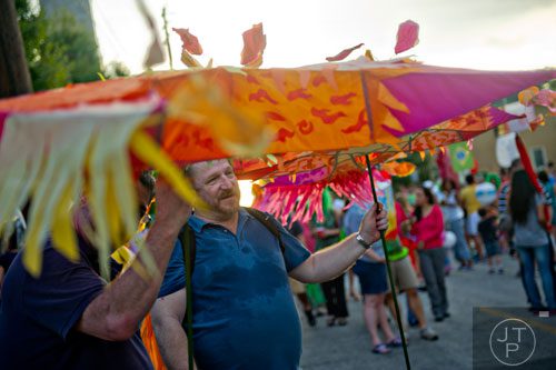Chris Creech (center) holds onto his lantern before the start of the Atlanta Beltline Lantern Parade on Saturday, September 6, 2014. 