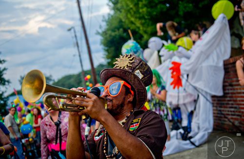 Dashill Smith plays his trumpet before the start of the Atlanta Beltline Lantern Parade on Saturday, September 6, 2014.