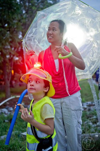 Dressed as a firefighter, Obi Edelstein (left) and his mother Silvia wait for the start of the Atlanta Beltline Lantern Parade on Saturday, September 6, 2014. 