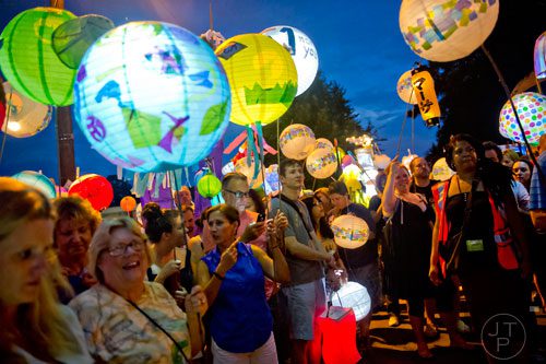 Hundreds of people carrying lanterns line up for the start of the Atlanta Beltline Lantern Parade on Saturday, September 6, 2014. 