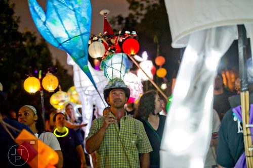Scott Peterson (center) carries a lantern during the Atlanta Beltline Lantern Parade on Saturday, September 6, 2014. 