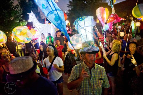 Scott Peterson (right) carries a lantern during the Atlanta Beltline Lantern Parade on Saturday, September 6, 2014. 