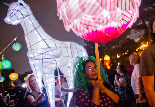 Melina Lozano (center) carries a lantern during the Atlanta Beltline Lantern Parade on Saturday, September 6, 2014. 